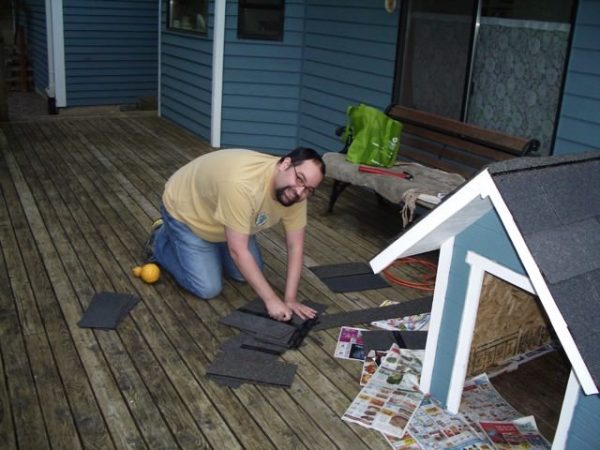 man building a dog house