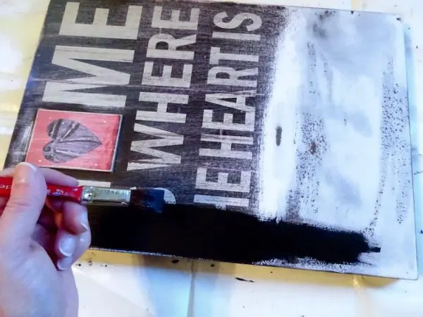painting a sign with black paint