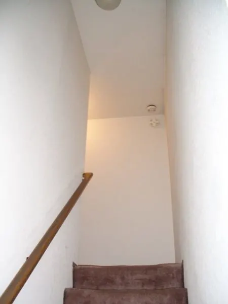 Narrow stairwell with blank wall