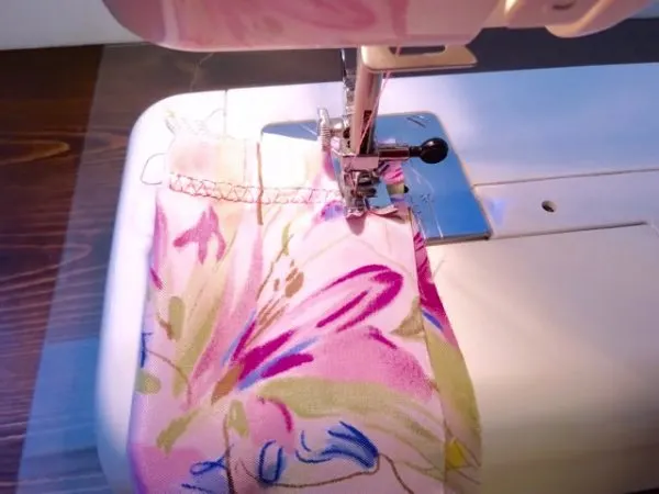 machine stitching around edges of scarf fabric