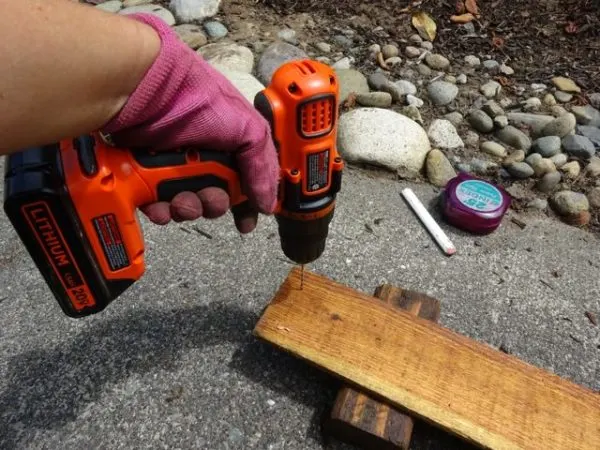 Drilling holes into a fence rail to prevent splitting