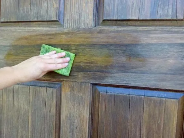 Prepare to stain a wood door.