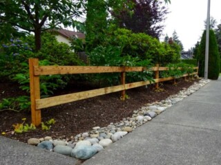Two rail wood fence makes a flower garden border