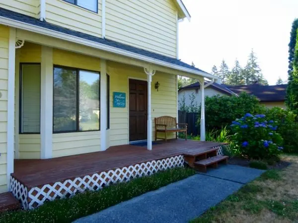 Yellow house with a wood front porch