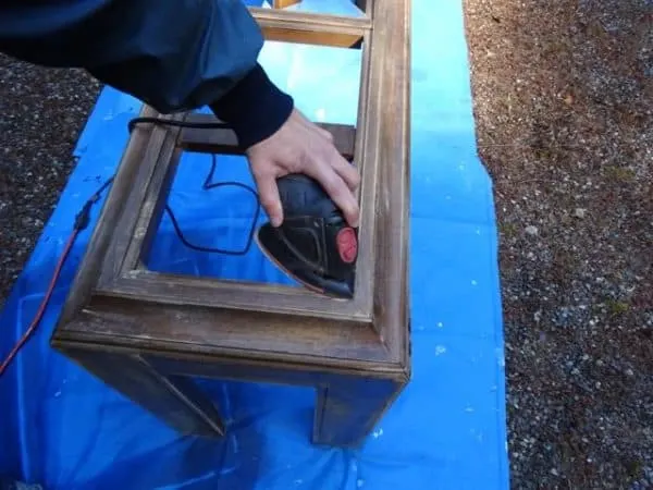 Sand a console table during a diy furniture makeover