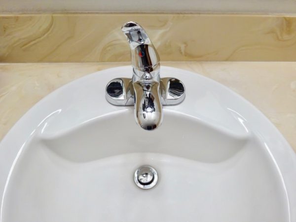 Open a sink faucet to drain a hot water tank