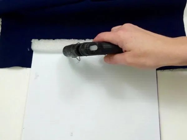 adding hot glue to a foam strip