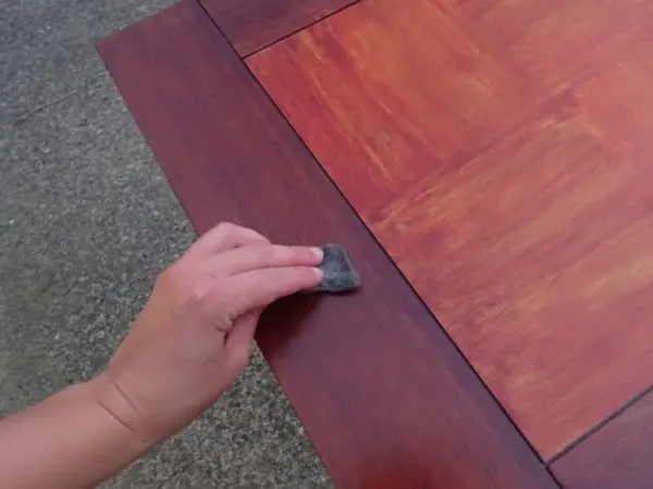 Sanding a wood table between coats of stain