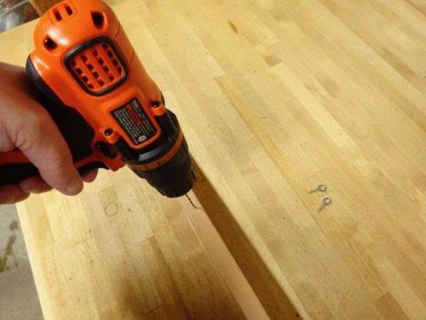 Holes for screw eyes in hanging map
