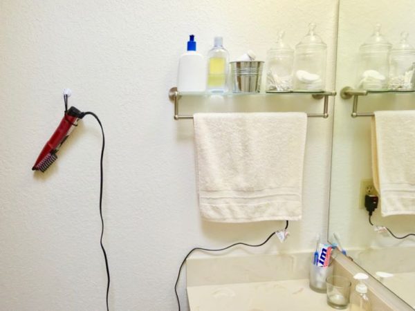 Hanging hair dryer on wall mount