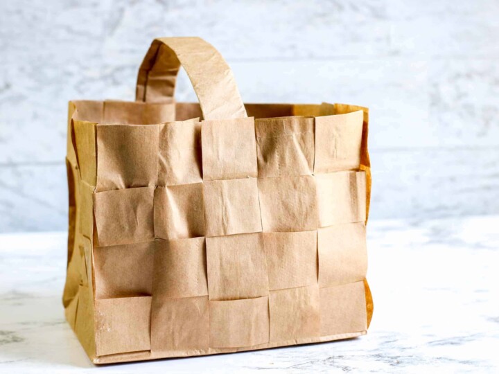 brown paper bag woven basket against marble background
