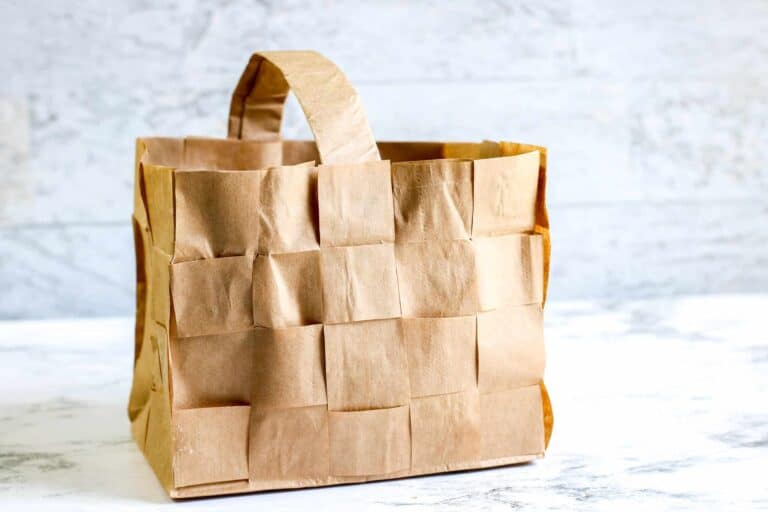 brown paper bag woven basket against marble background