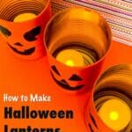 three jack-o-lanterns tin cans on table top