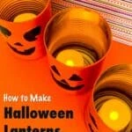 three jack-o-lanterns tin cans on table top