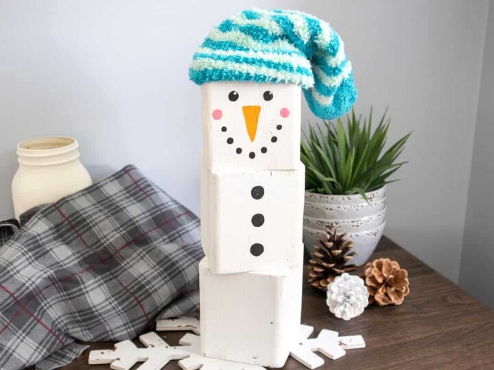 painted wood block Snowman with blue cap on table