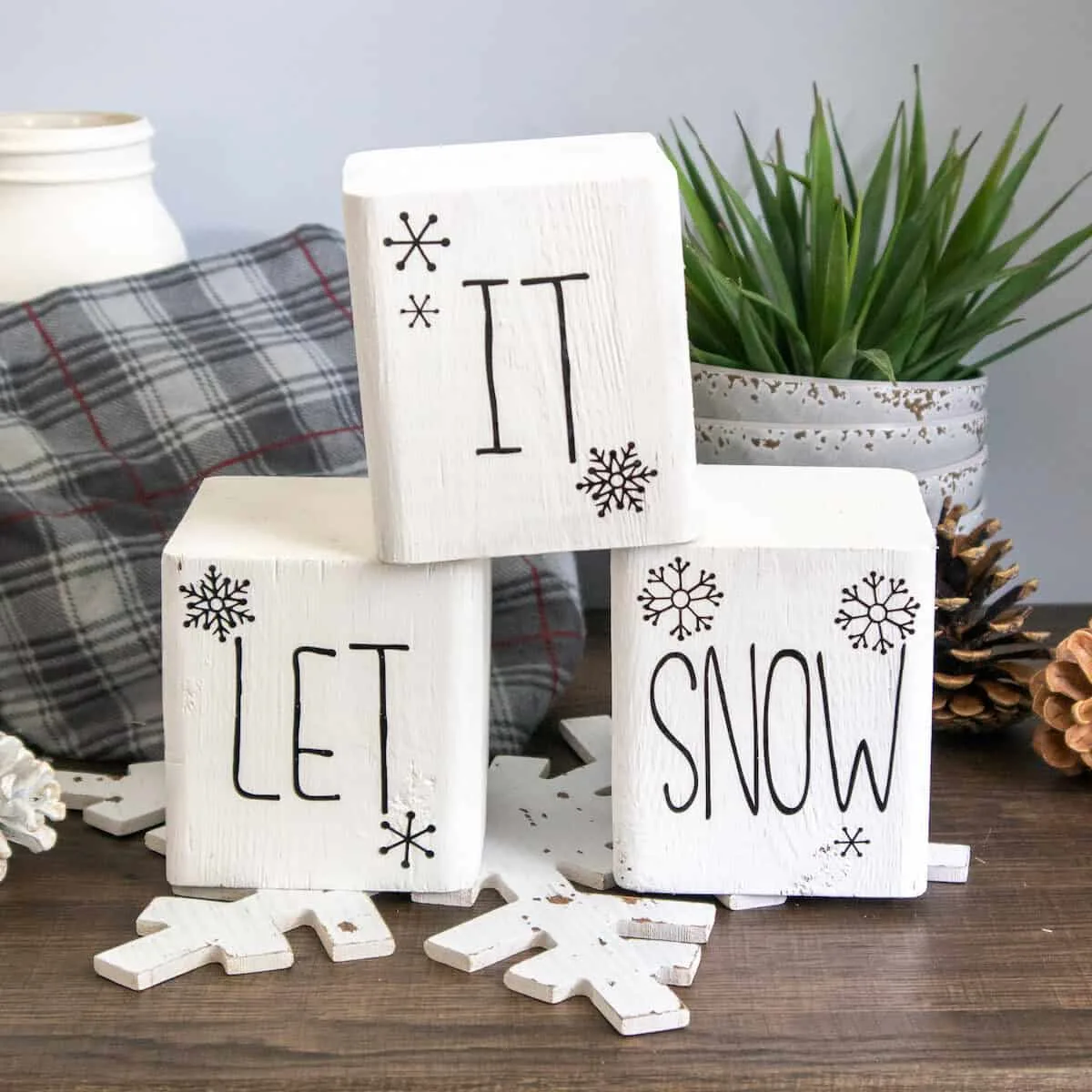 painted wood block Snowman word stencils on table