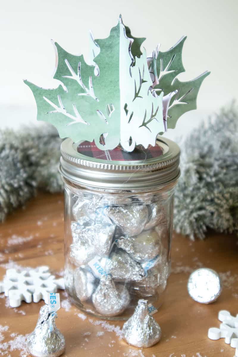 paper holly leaf holiday jar topper on mason jar filled with candy