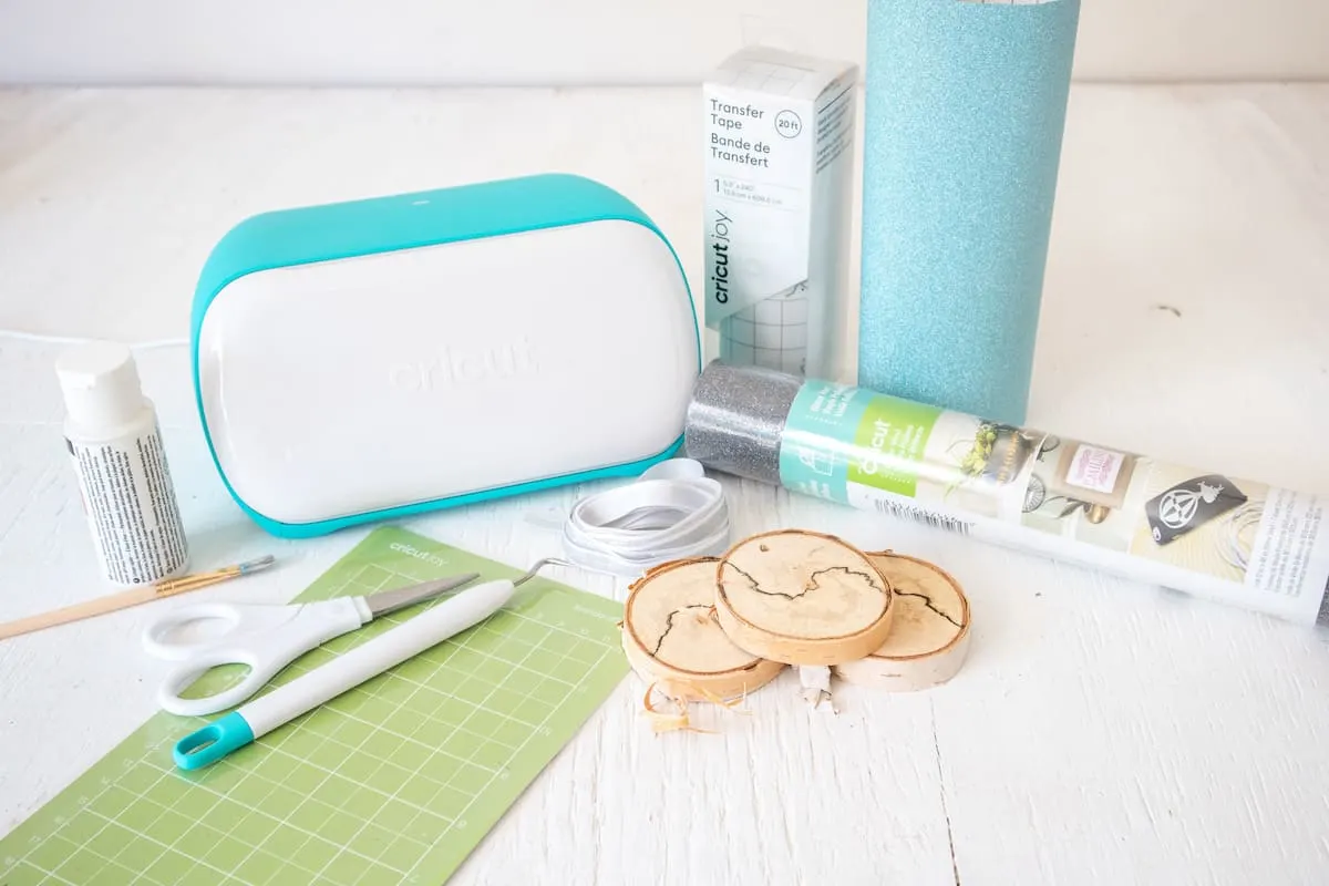 Cricut Joy machine with wood slices and vinyl 