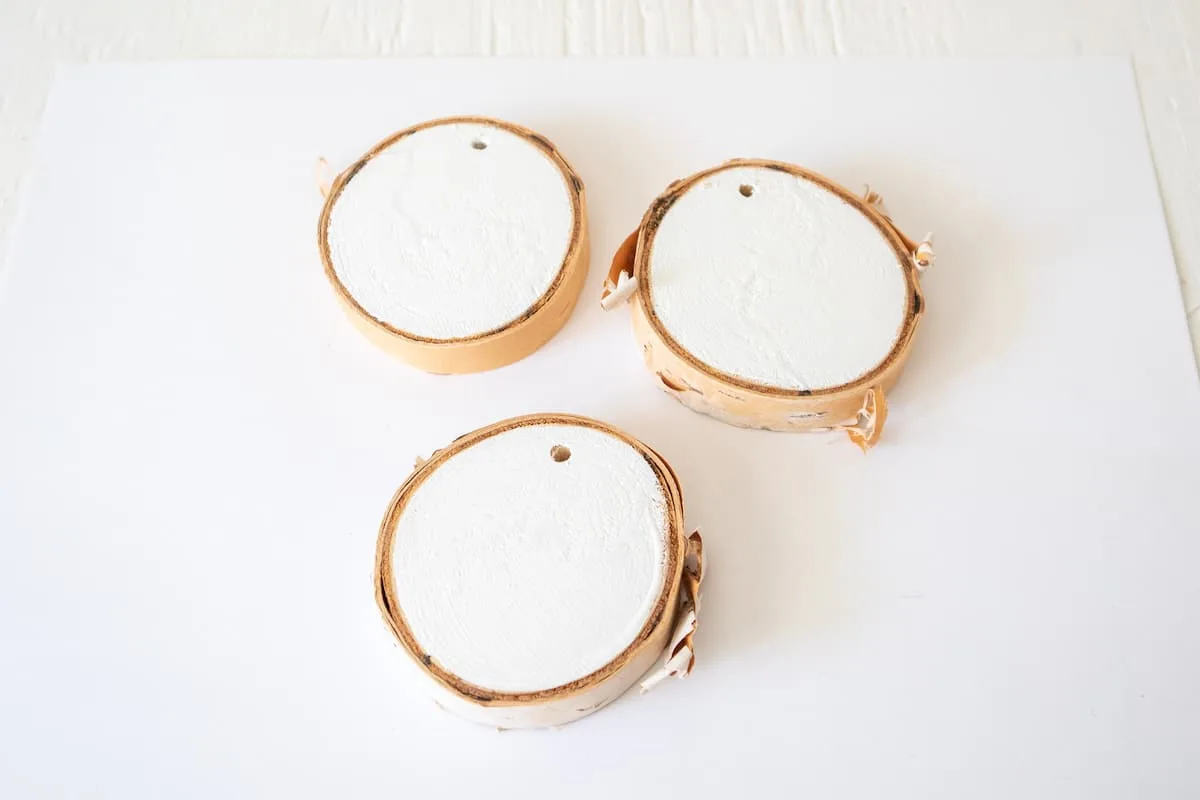 white painted wood slices on table