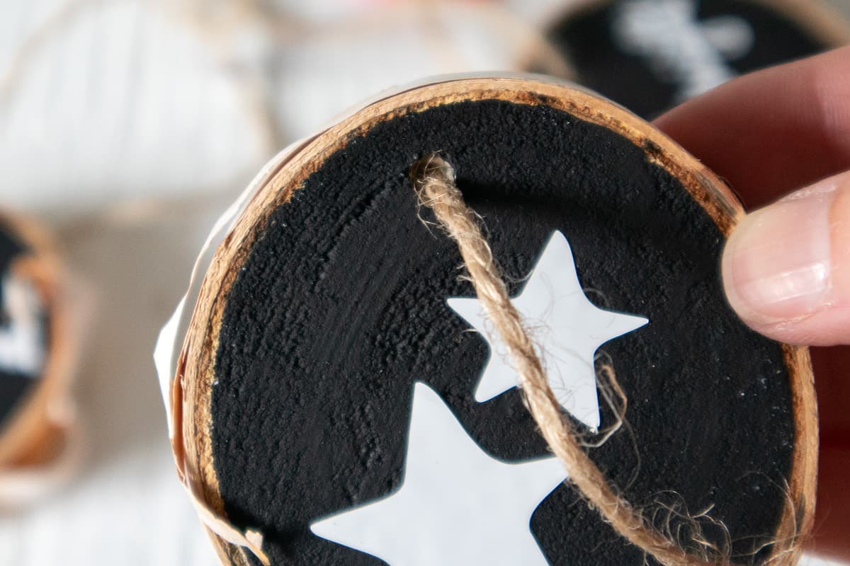 close up of lettered wood slice ornament