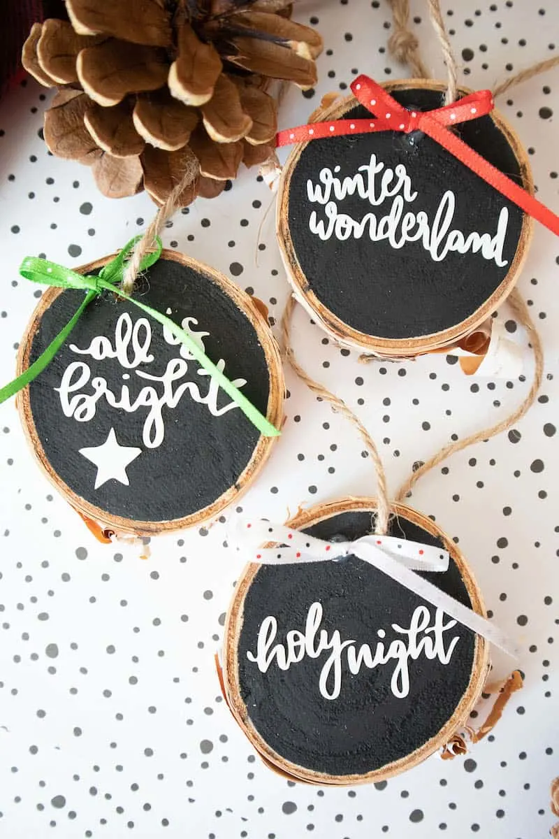 Lettered wood slice ornaments with twine and fabric bows