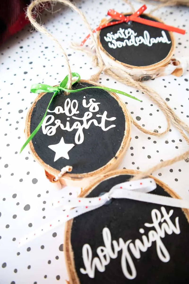 Lettered wood slice ornaments with twine and fabric bows