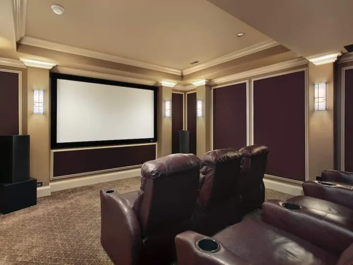 Theater room in luxury home with lounge chairs