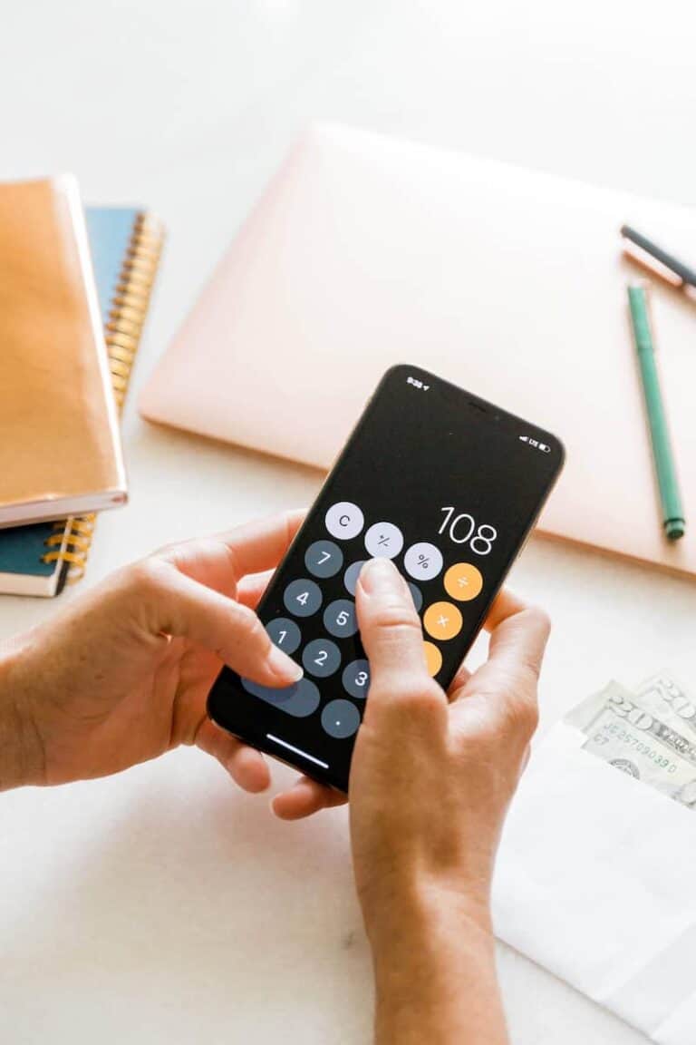 woman using calculator on mobile phone