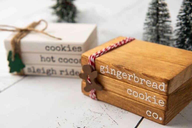 stacked wooden Christmas books on white table