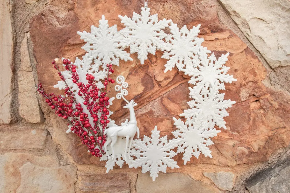 winter wonderland wreath hanging on a rock wall