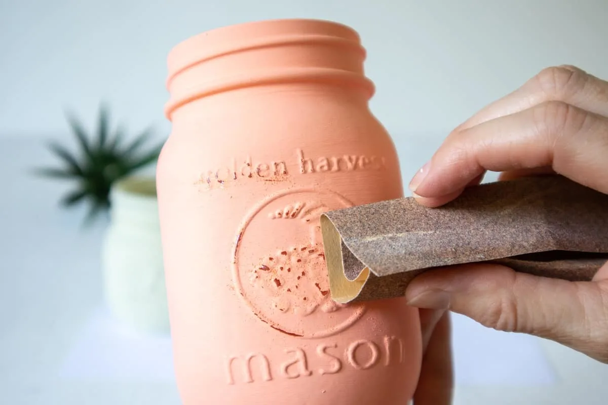 distressing painted mason jar with sandpaper