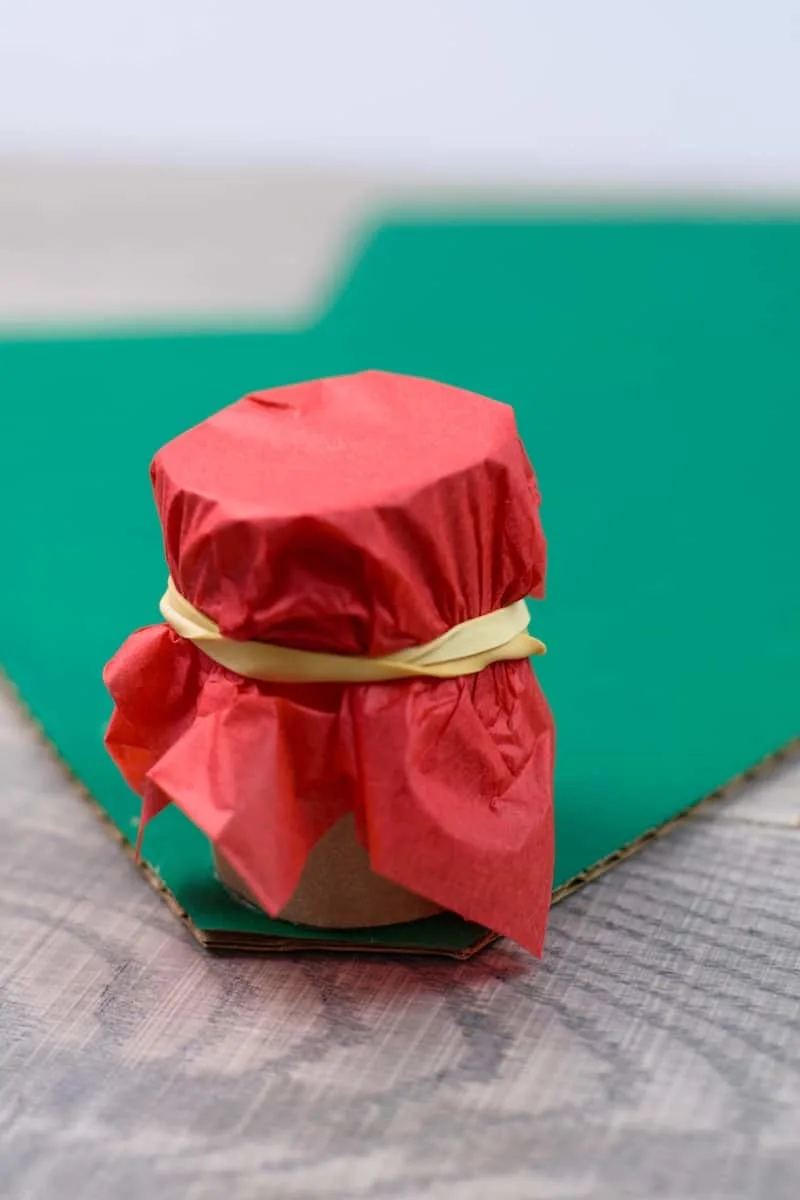 red tissue paper wrapped around paper roll