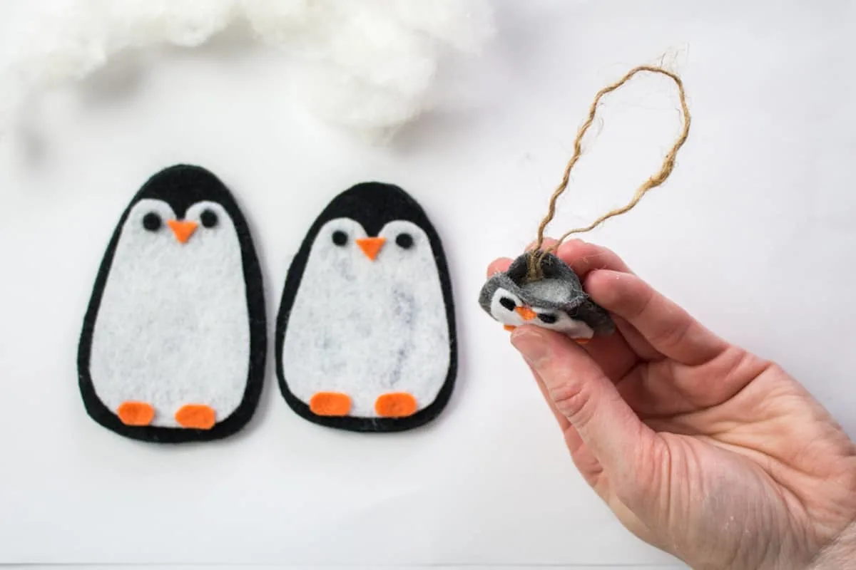 Adding twine hook to penguin ornament