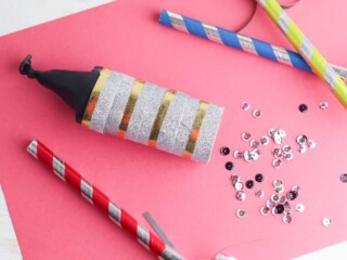 doy confetti cannon on pink background with sequins nearby