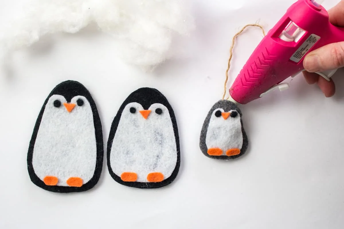 Hot glueing twine to penguin ornament