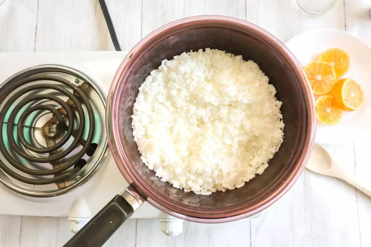 Warming soy wax flakes for a candle