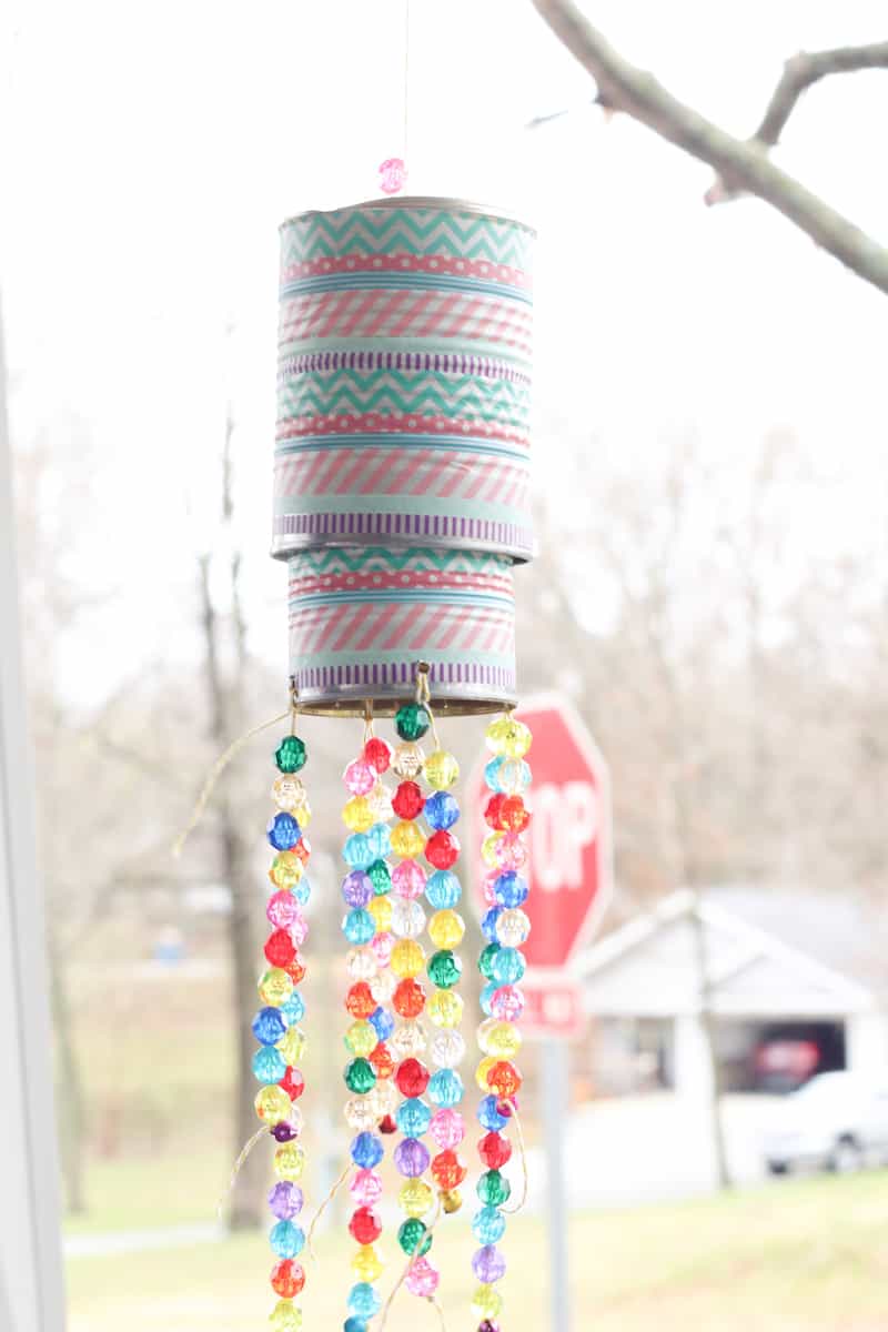 tin can wind chimes hanging on porch