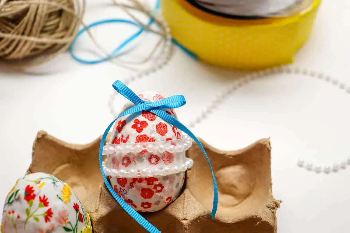 blue ribbon bow on fabric covered egg