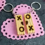 tumbling towers game Block Keychain with pink heart background