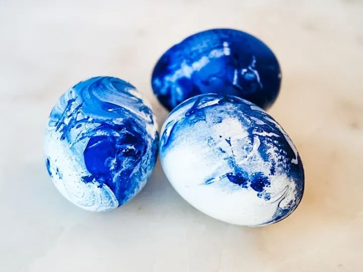 nail polish easter eggs cluster on white marble