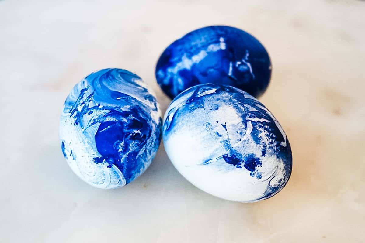 nail polish easter eggs cluster on white marble