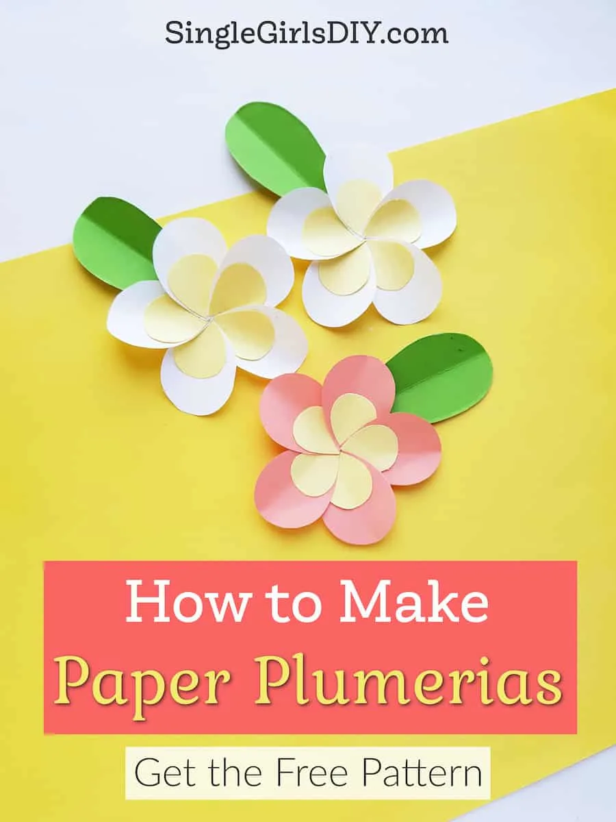 three colorful DIY paper plumerias on yellow background