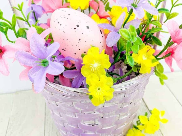 Easter eggs and flowers in a purple basket