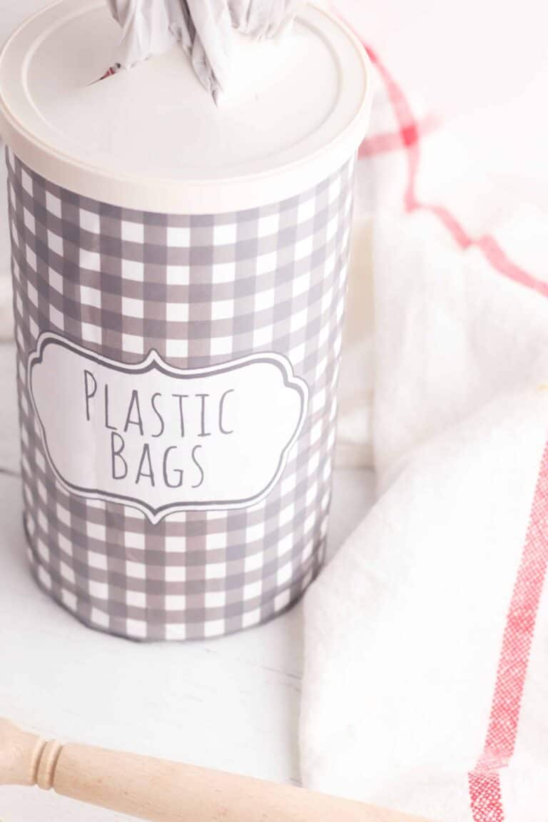 upcylced oatmeal container into a grocery store bag holder