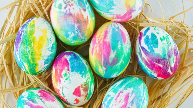 Tie-dye Easter eggs nestled in straw.