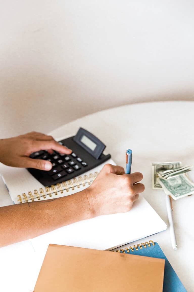 woman using a calculator to budget
