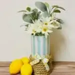 decoupaged paper napkin glass vase with lemons on wood table