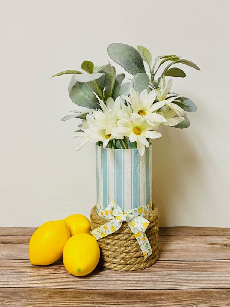 decoupaged paper napkin glass vase with lemons on wood table
