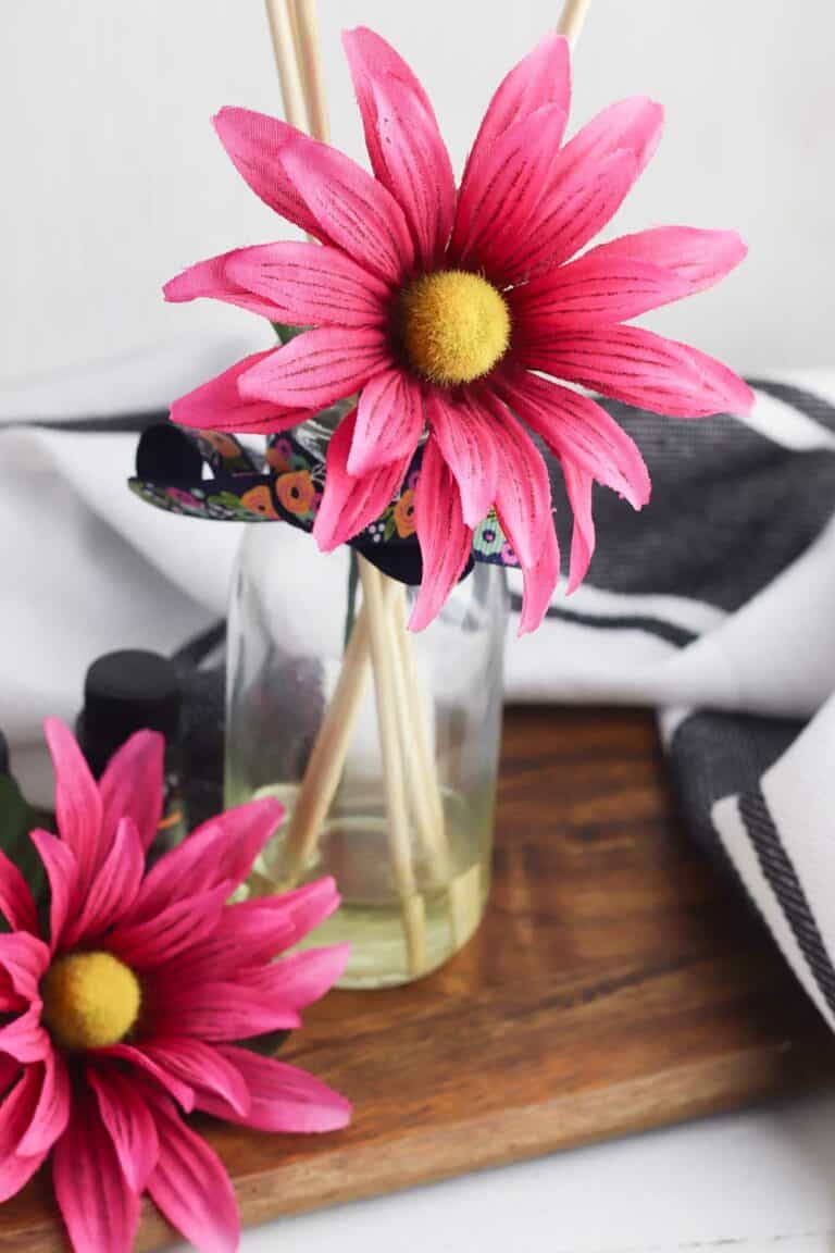 faux flower in bottle of essential oils