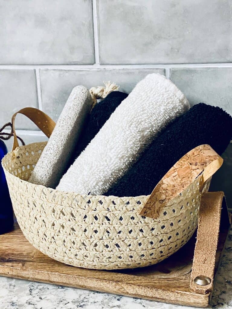 straw hat wicker basket stuffed with washcloths